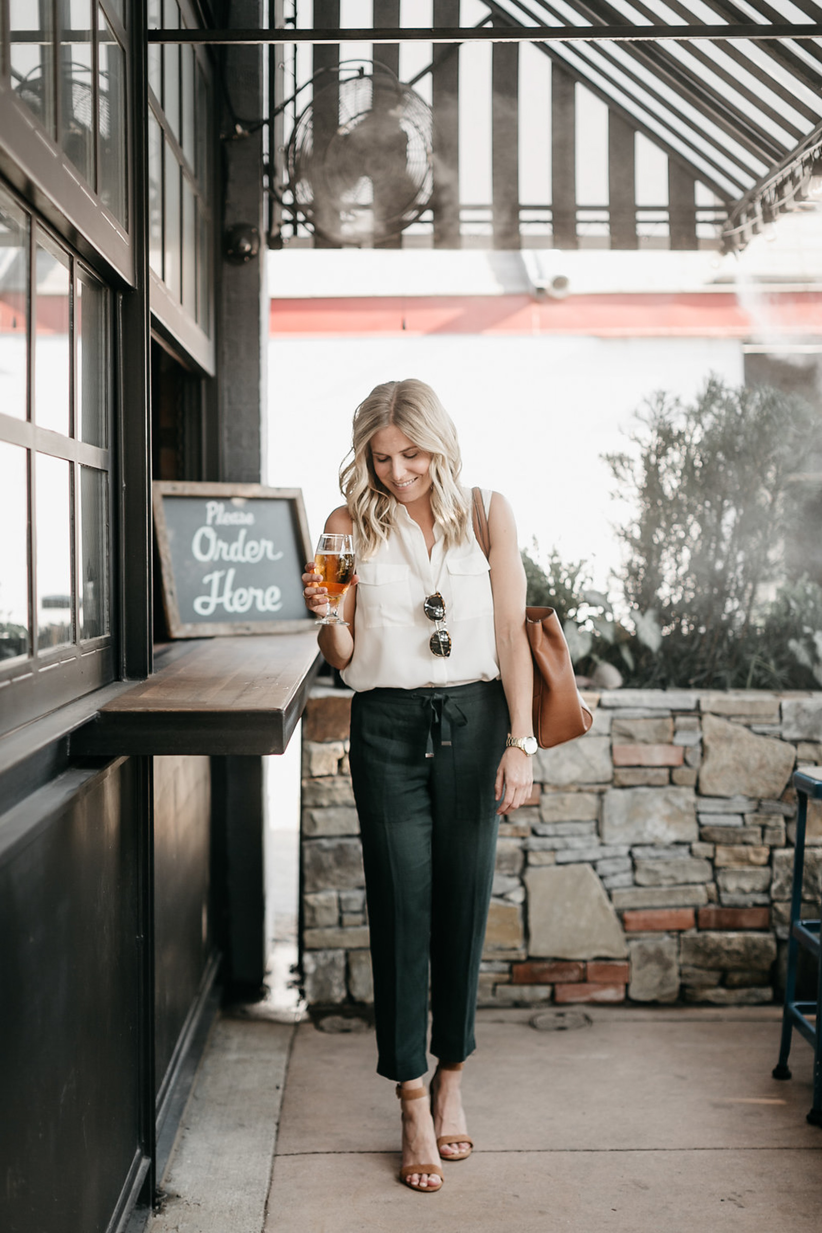 woman in LAUREL TAVERN and holding a glass of beer